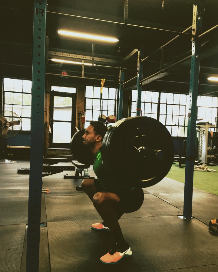 Venkat at the bottom of a back squat in a CrossFit gym